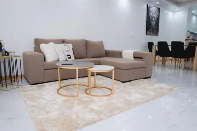 a living room with a couch and two tables at Saw Paradise in Praia T2 in Praia