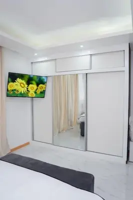 a room with a mirror and a tv on the wall at Saw Paradise in Praia T2 in Praia