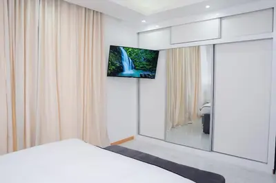 a bedroom with a bed and a tv on a wall at Saw Paradise in Praia T2 in Praia