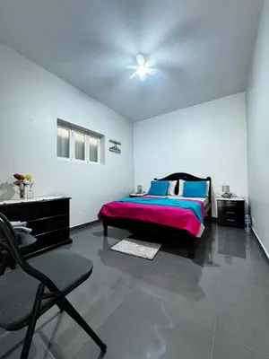 a bedroom with a bed and a chair in it at Cozy Home with Terrace Views! in Ponta do Sol