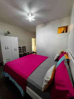 a bedroom with a large bed with a pink blanket at Cozy Home with Terrace Views! in Ponta do Sol