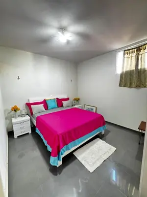 a bedroom with a large bed with a pink blanket at Cozy Home with Terrace Views! in Ponta do Sol