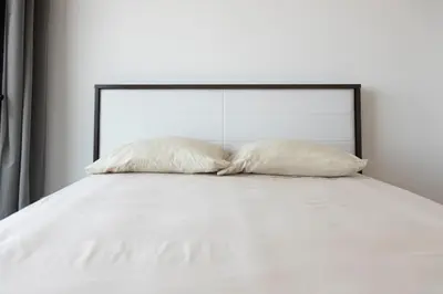 two white pillows sitting on top of a bed at Lux 3-BR: Panoramic Sea View & Rooftop Pool in Praia