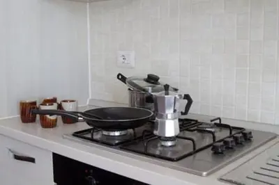 a kitchen stove with a pan on top of it at Ideal Location in Sal Rei