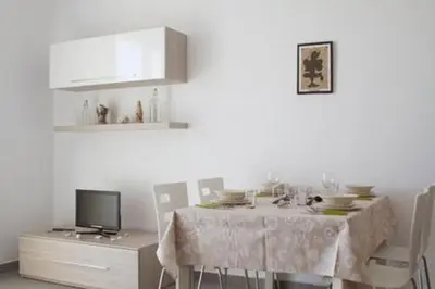 a dining room with a table with chairs and a tv at Ideal Location in Sal Rei