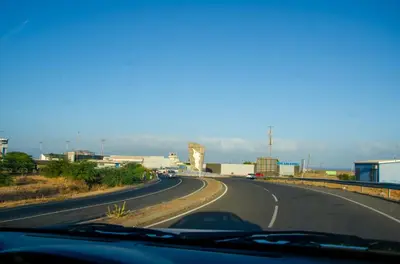 a road with a car driving down it at Apartamento T2 Equipado e Aconchegante. in Praia