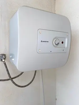 a white box on a wall with a cord at Apartamento T2 Equipado e Aconchegante. in Praia