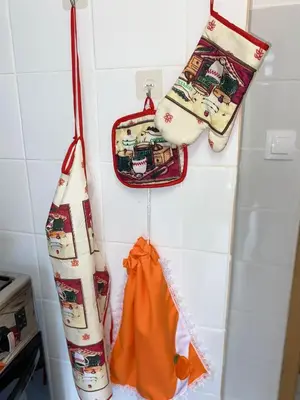 a kitchen with two towels and a bag on the wall at Apartamento T2 Equipado e Aconchegante. in Praia