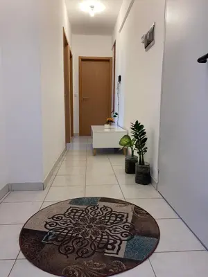 a hallway with a bathroom with a rug on the floor at Apartamento T2 Equipado e Aconchegante. in Praia
