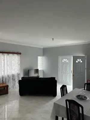 a living room with a couch and a table at Casa dos Amigos in Calheta de São Miguel