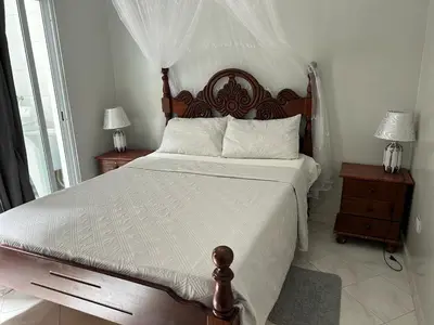 a bedroom with a large bed with a wooden headboard at Casa dos Amigos in Calheta de São Miguel