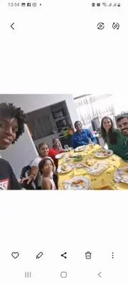 a group of people sitting around a table with bananas at Casa dos Amigos in Calheta de São Miguel