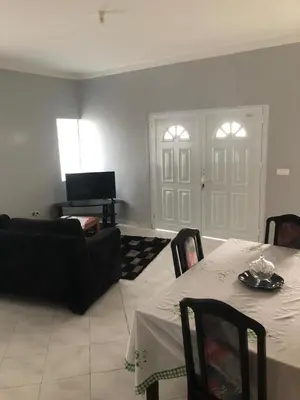 a living room with a table and a couch at Casa dos Amigos in Calheta de São Miguel