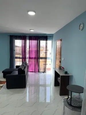 a living room with a couch and a table at madison place in Praia