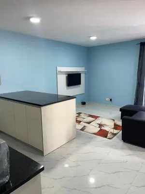 a living room with a counter and a blue wall at madison place in Praia