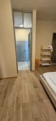 an empty room with a bed and a sliding glass door at Flat City Center Mindelo in Mindelo