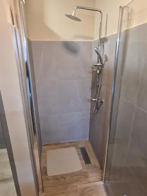a shower with a glass door in a bathroom at Flat City Center Mindelo in Mindelo