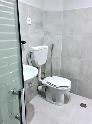 a bathroom with a toilet and a sink at MorabezaHome- Apartment Tati in Mindelo