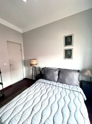 a bedroom with a large bed in a room at MorabezaHome- Apartment Tati in Mindelo