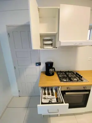 a kitchen with a stove and a counter top at MorabezaHome- Apartment Tati in Mindelo