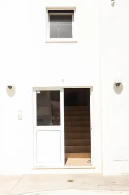 an open door on a white building at 2 bdr apt in Palmarejo Baixo, near seafront - LCGR in Praia