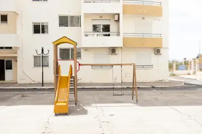 a playground in front of a building at 2 bdr apt in Palmarejo Baixo, near seafront - LCGR in Praia