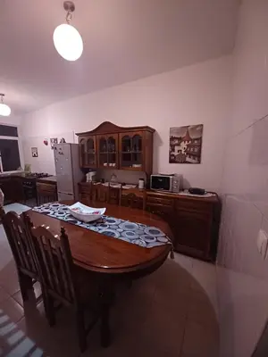 a dining room with a table and a kitchen at Repousando II in Ribeira Grande