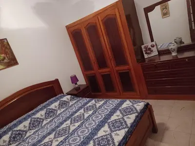 a bedroom with a bed and a wooden cabinet at Repousando II in Ribeira Grande