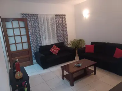 a living room with two black couches and a coffee table at Repousando II in Ribeira Grande