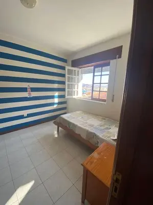 a room with a bed and a window at Vivenda com pátio, no coração do Mindelo in Mindelo