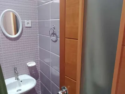 a bathroom with a sink and a mirror at Niclas ApartamentoT1 in Praia