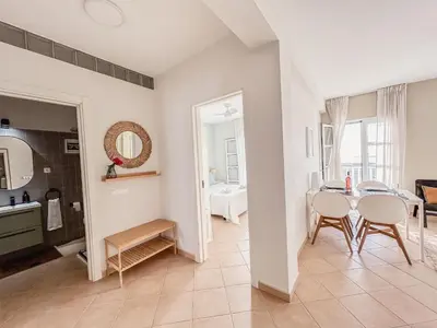a kitchen and dining room with a table and chairs at Papaya Apartments Boa Vista in Sal Rei