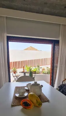 a table with bananas and a view of a patio at Papaya Apartments Sal Island in Santa Maria
