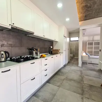a kitchen with white cabinets and a stove at Papaya Apartments Sal Island in Santa Maria