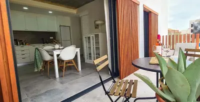 a small balcony with a table and a kitchen at Papaya Apartments Sal Island in Santa Maria