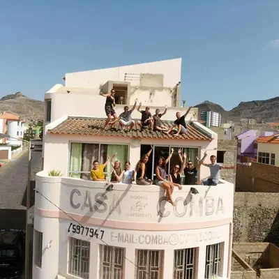 a group of people sitting on top of a building at Casa Comba in Mindelo