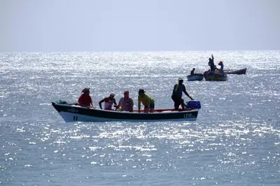 a group of people in a boat on the water at Casa Comba in Mindelo