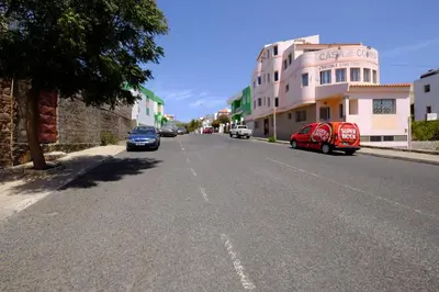 a street with cars parked on the side of the road at Casa Comba in Mindelo