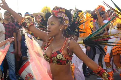 a woman in a group of people in a parade at Casa Comba in Mindelo