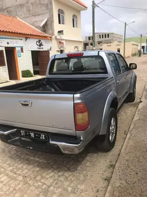 a pick up truck parked on the side of a street at Apto Martins - Prédio Residencial Inês nº23 in Vila do Maio