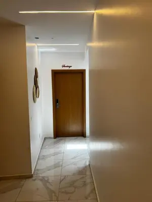 a hallway with a brown door and a tile floor at Pensão Gonçalves in Calheta de São Miguel