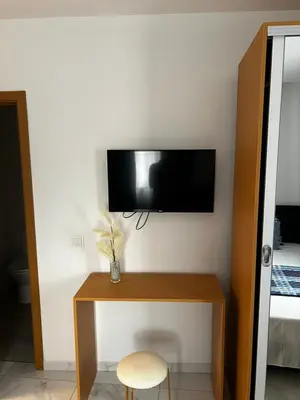 a room with a tv on a wall at Pensão Gonçalves in Calheta de São Miguel