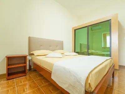 a bedroom with a large bed and a night stand at Residencial LiviaMilena Santa Maria in Santa Maria