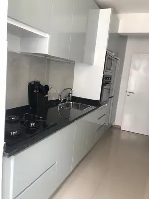 a white kitchen with a sink and a stove at Apartamento Da Costa in Mão para Trás