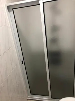 a sliding glass shower door in a bathroom at Apartamento Da Costa in Mão para Trás