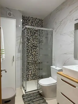 a bathroom with a shower and a toilet and a sink at SMR AP08 in Santa Maria