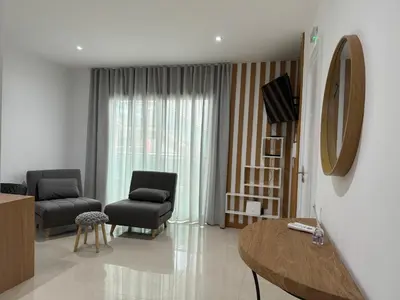 a living room with two chairs and a table at SMR AP08 in Santa Maria