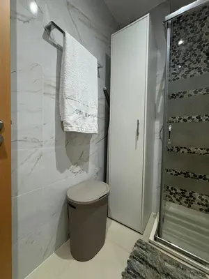 a white bathroom with a toilet and a shower at SMR AP08 in Santa Maria