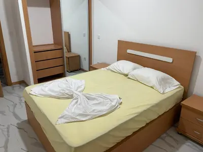 a bedroom with a large bed with a wooden headboard at Rosario’s Residence in Praia