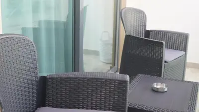 two wicker chairs and a table with a bowl on it at Geams Sal Suite in Santa Maria